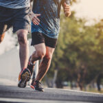 young people runner running on running road in city park